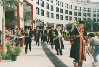 A HKUST faculty member holding the mace