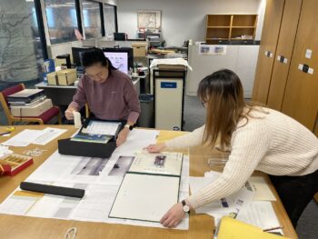 Images of our University Archive and Special Collection teams mocking up the display