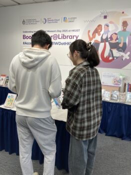 2 Young People looking at the books in the book display