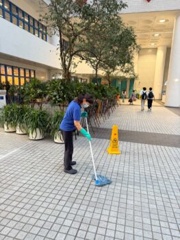 Cleaning lady mopped the floor after flower picking