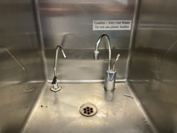 Fountain with really hot water warning sign