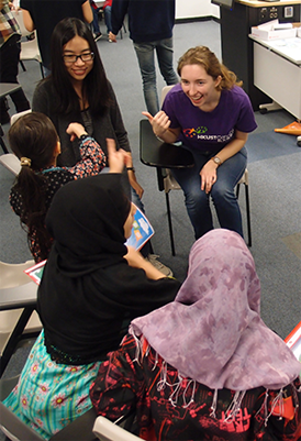 Volunteer chatting with ethnic minority children