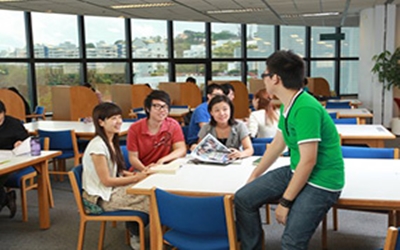 photo of happy students talking around a table